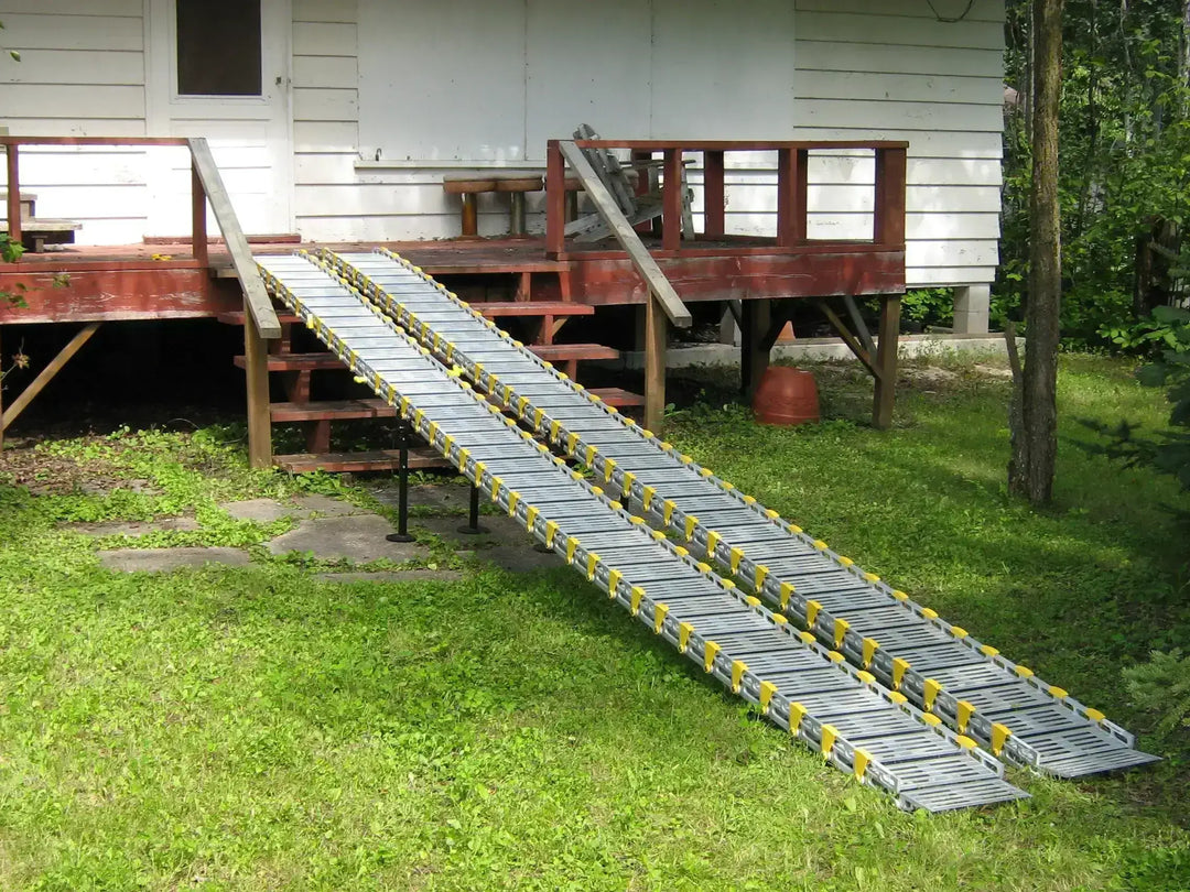 12" Roll-A-Ramp track ramps from Reliable Ramps setup with a wooden deck down to the grass