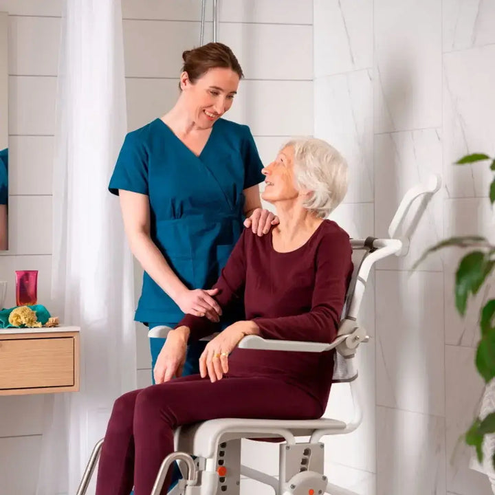Caregiver assisting an elderly woman in a bathroom setting