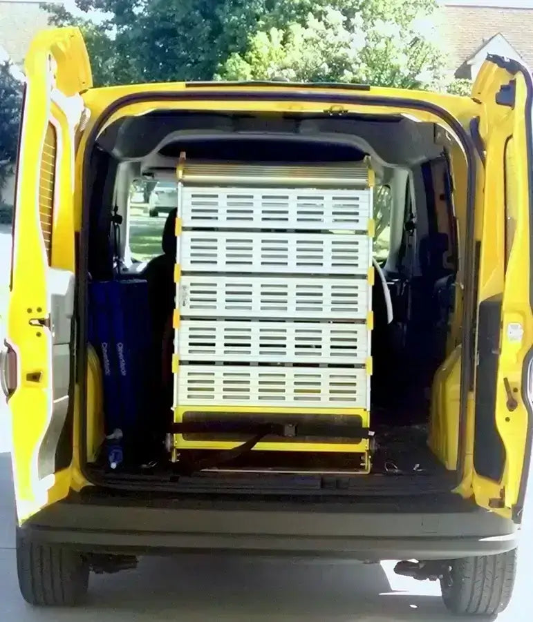 Roll-A-Ramp manual van ramp from Reliable Ramps showing a back entrance of a yellow van