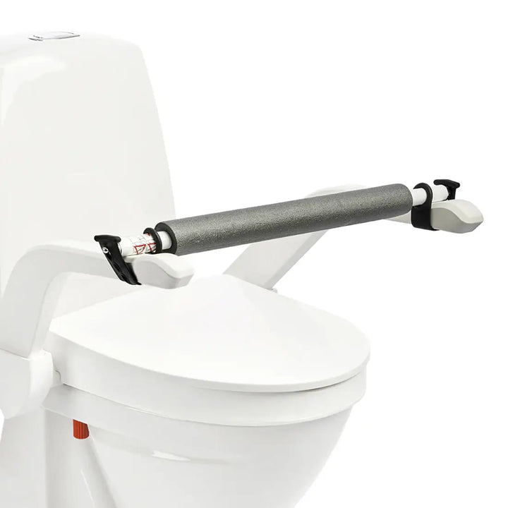 Toilet safety rail attached to a white toilet on a white background