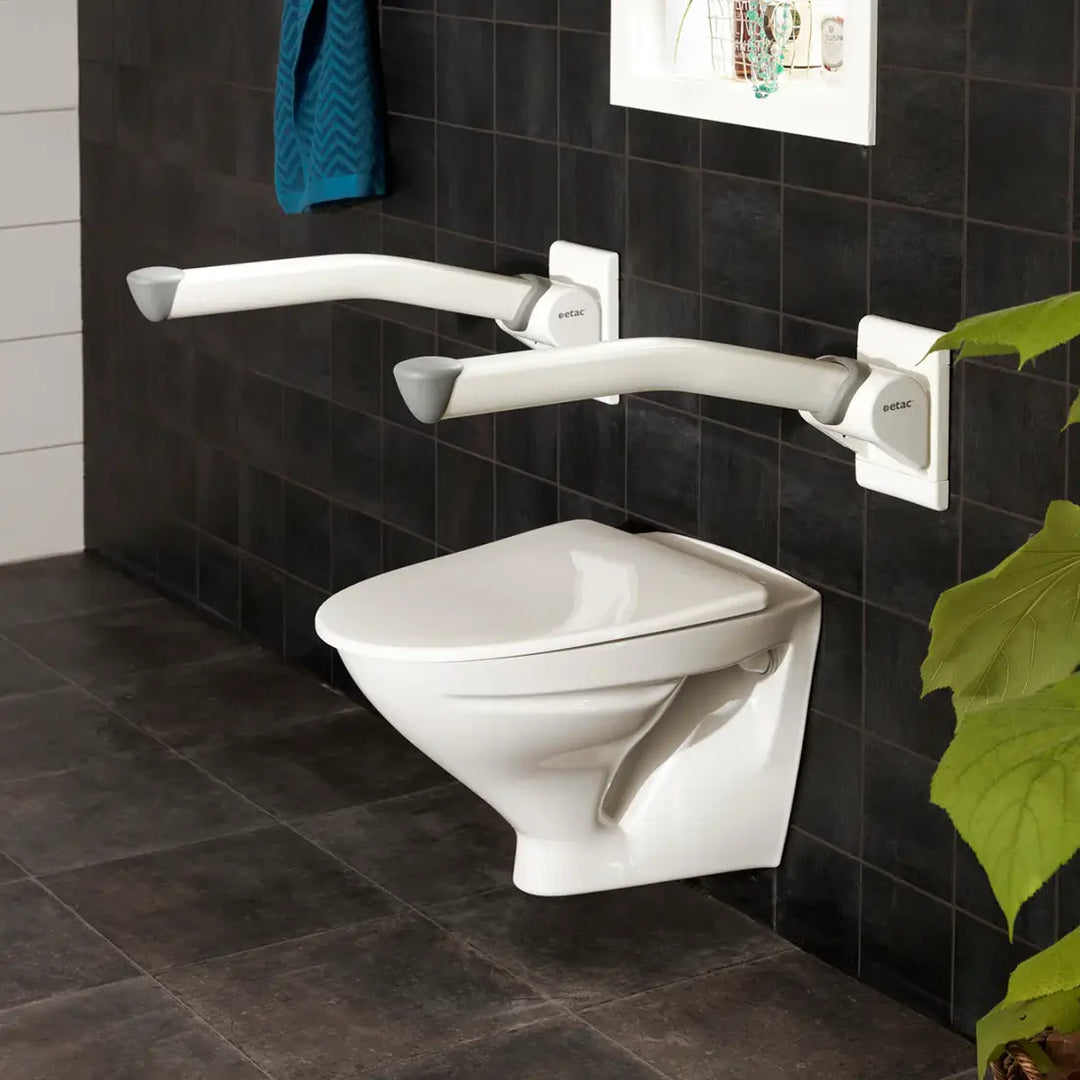 Wall-mounted toilet with grab bars in a bathroom setting