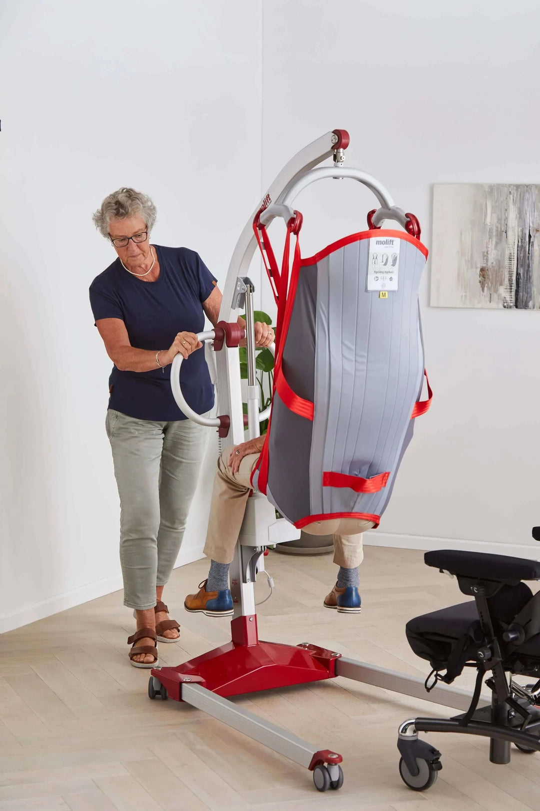 Molift - RgoSling Highback Padded Patient Sling being used by a patient and their nurse