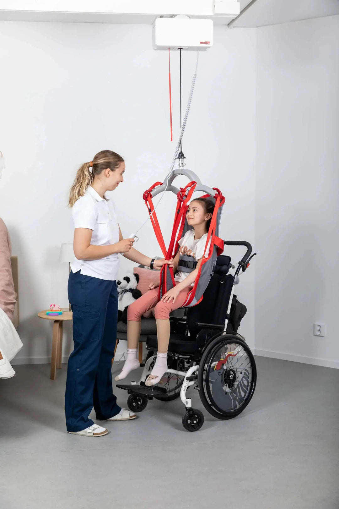 Molift Air 200 Ceiling Lift Motor being used by a patient Reliable Ramps