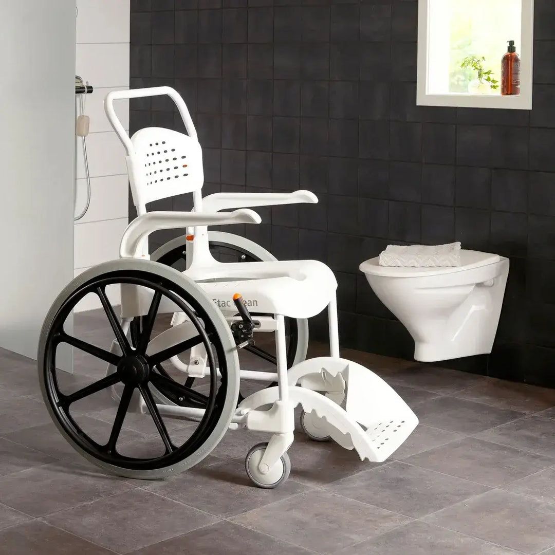 White wheelchair with shower attachment in a bathroom setting