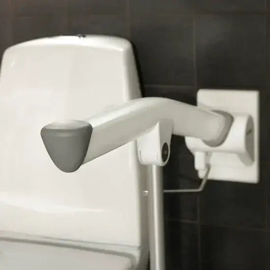 Handheld shower head with adjustable arm against a tiled wall