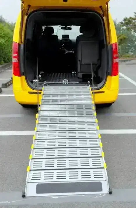 Roll-A-Ramp manual van ramp from Reliable Ramps deployed out a kia carnival