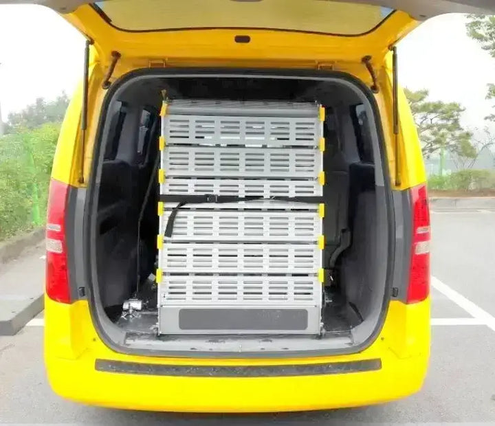 Roll-A-Ramp manual van ramp from Reliable Ramps folded up into a kia carnival