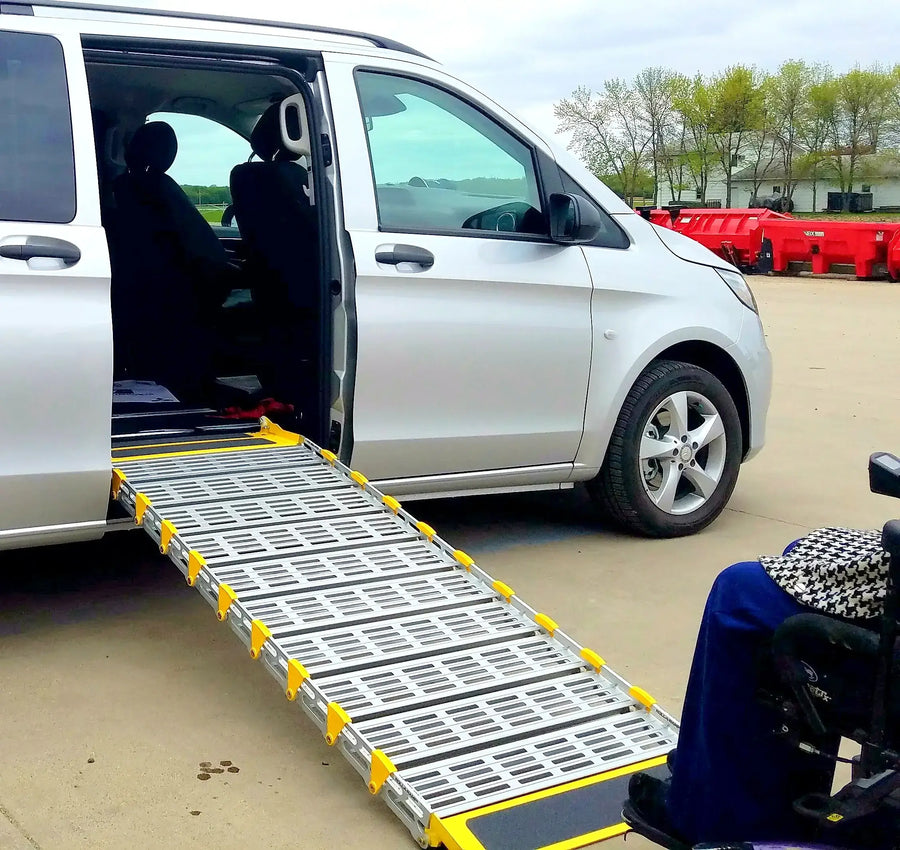 Roll-A-Ramp manual van ramp from Reliable Ramps being used on the side of a gray ramp