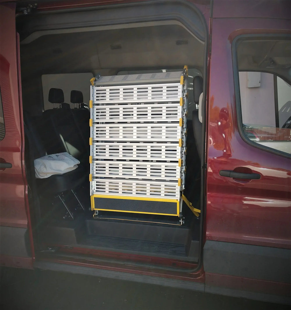 Roll-A-Ramp manual van ramp from Reliable Ramps being used in a red van