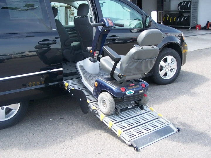 Roll-A-Ramp manual van ramp from Reliable Ramps being used on the side of a van with a motor scooter