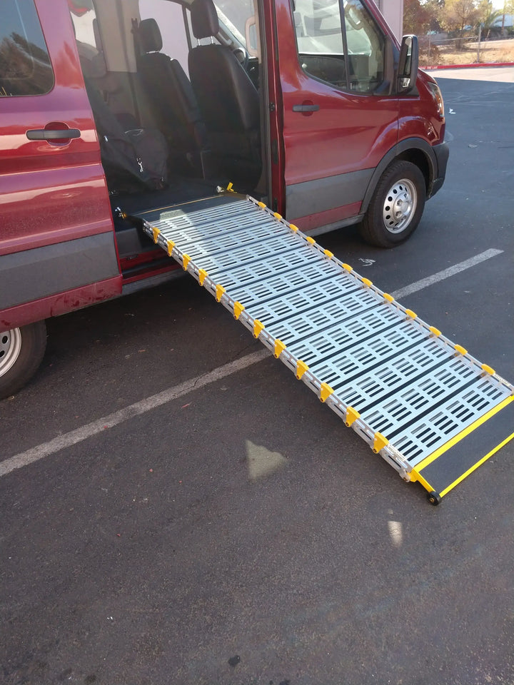 Roll-A-Ramp manual van ramp from Reliable Ramps being used unfolded out the side of a red van