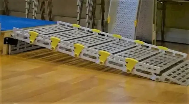 Roll-A-Ramp Seg Mount Brackets From Reliable Ramps being used with a ramp on wooden surface