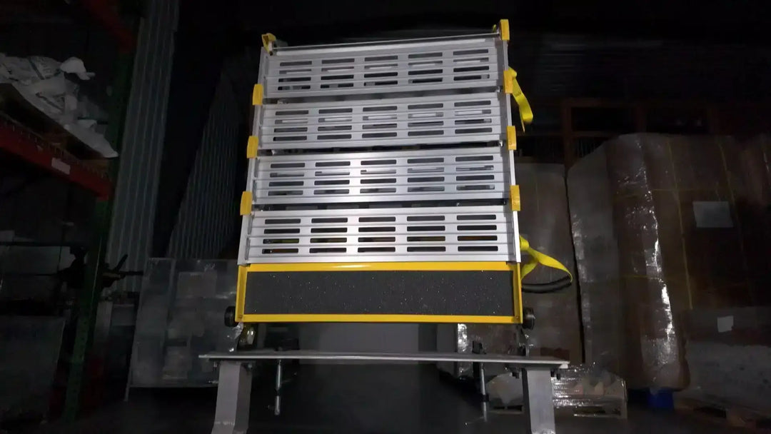 roll-a-ramps assisted bi fold van ramp on reliable ramps head on view in warehouse