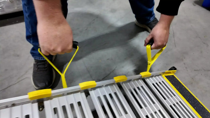 roll-a-ramps assisted bi fold van ramp on reliable ramps man holding two handles