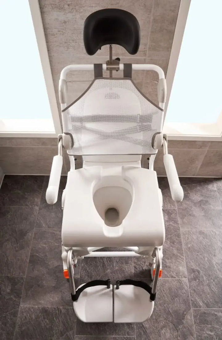 White toilet with adjustable seat in a bathroom setting