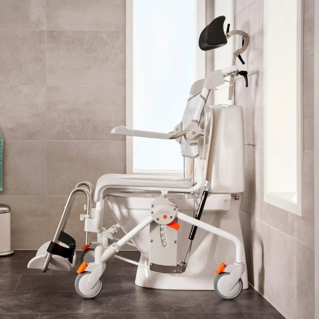 White medical chair with wheels in a bathroom setting