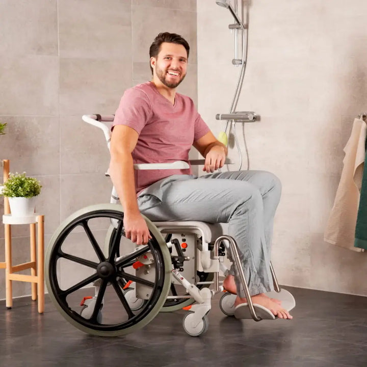 Man using a wheelchair in a bathroom setting