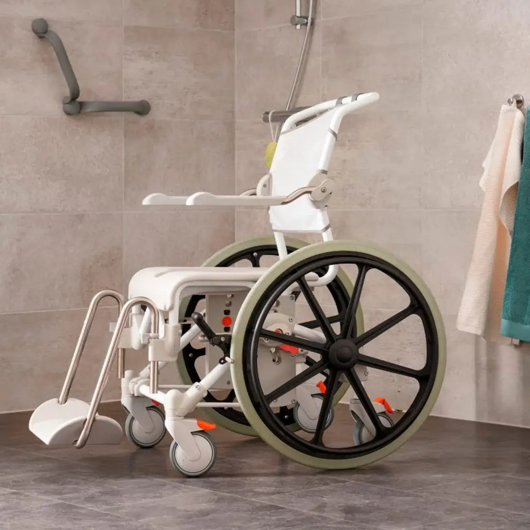 White wheelchair with shower attachment in a bathroom setting