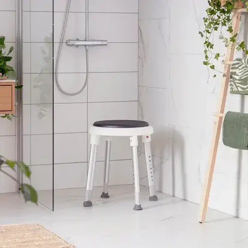 White stool with a black seat in a bathroom setting