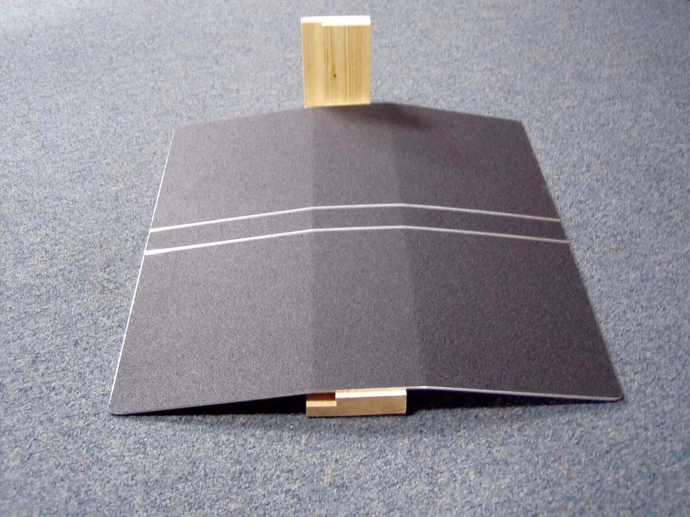 Guldmann - Stepless Doorstep Mobility Ramp sitting on a display floor over a 2x4 piece of wood