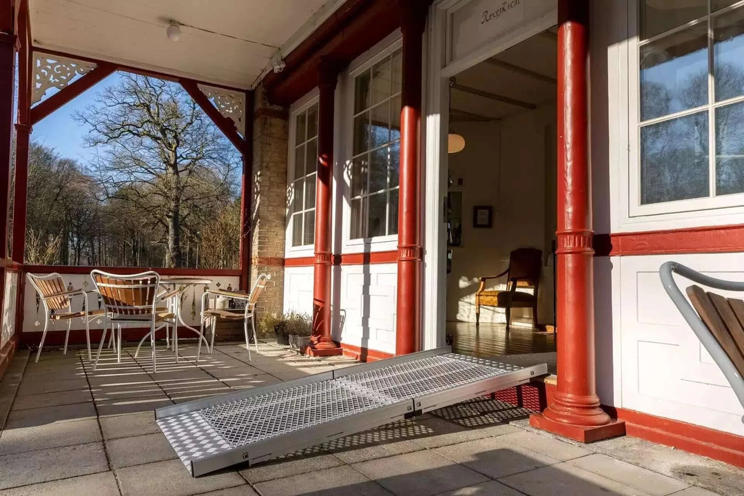 Guldmann - Stepless Wide Folding Pro Portable Wheelchair Ramp setup outside a home