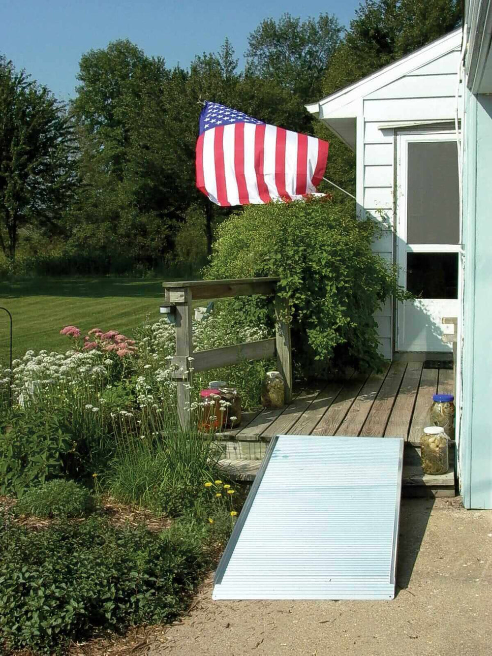 AlumiRamp - AlumiLite Solid Aluminum Curb Wheelchair Ramp next to a house outside