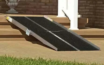 PVI - Aluminum Multi-Fold Portable Wheelchair Ramp being shown going over a few steps at a home's entrance