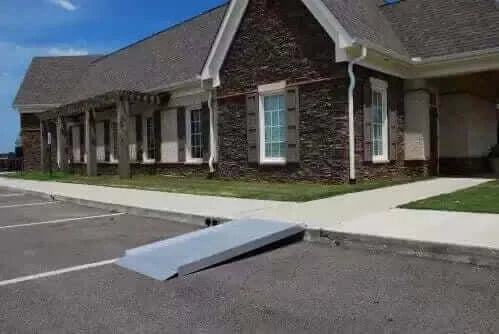 American Access - Sidekick Portable Solid Aluminum Wheelchair Ramp - ramp being used on a curb in front of a business