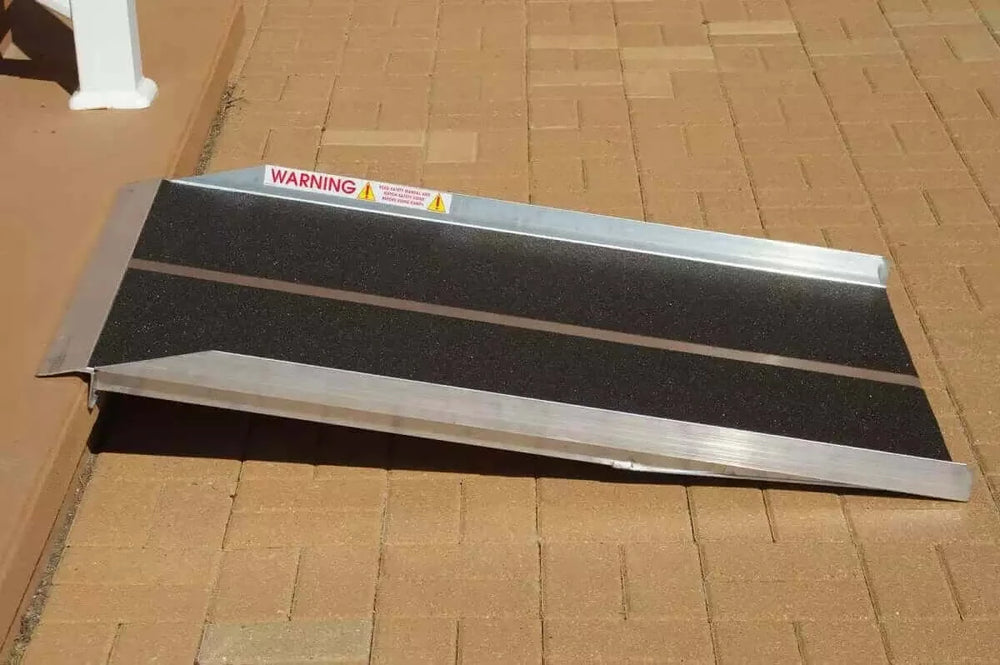 PVI - Aluminum Solid Mobility Wheelchair Ramp sitting in front of a home and a one step threshold