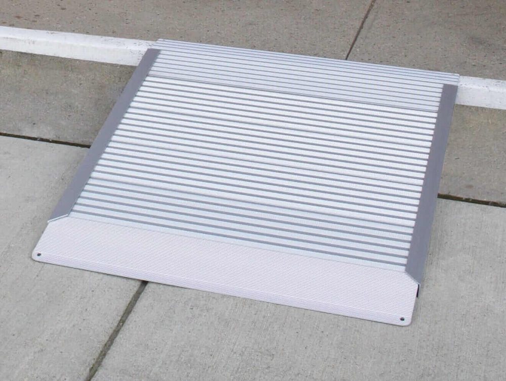 AlumiRamp - Aluminum Threshold Ramp for Wheelchairs - zoomed in view being used on a one step entrance