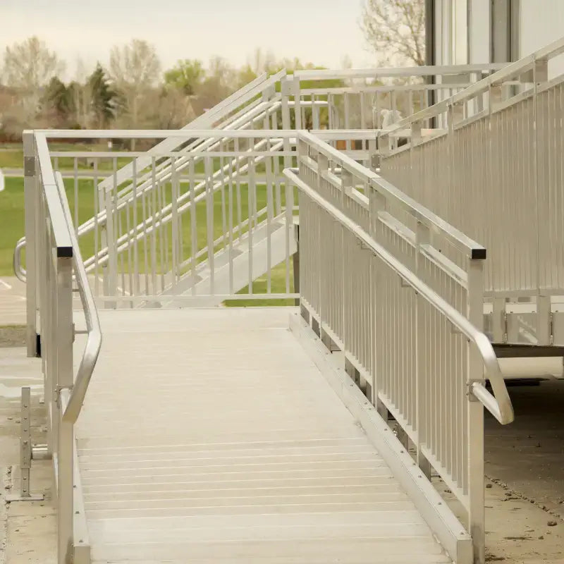 close up picture of a modular wheelchair ramp with a steps in the background