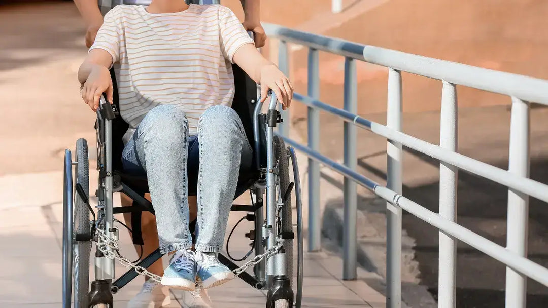 woman being pushed up a wheelchair ramp