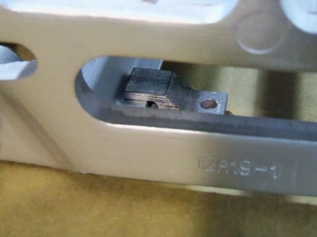 Close-up of a car door handle mechanism with a key inserted.