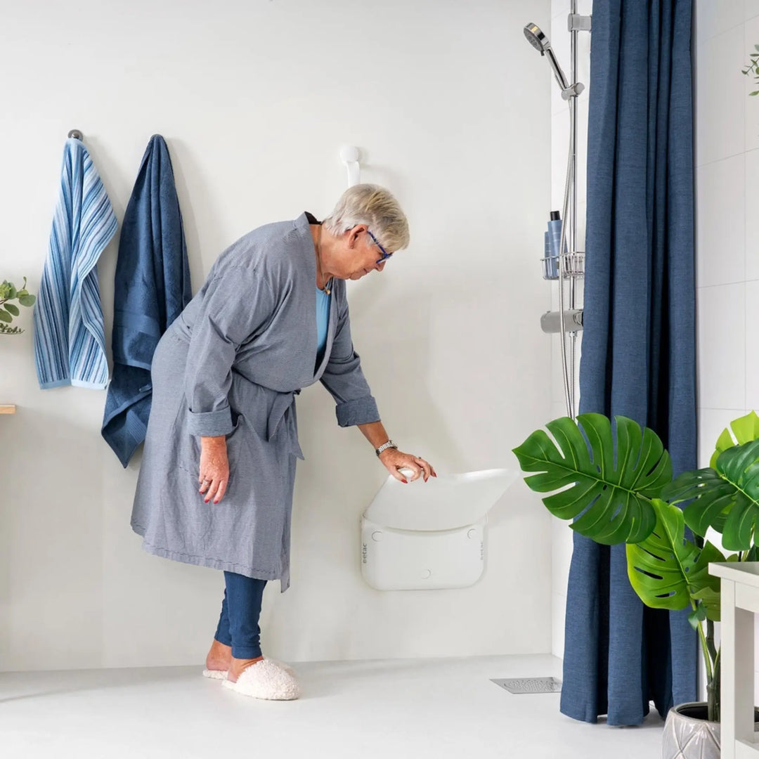 ETAC relax shower seat being held by woman in robe