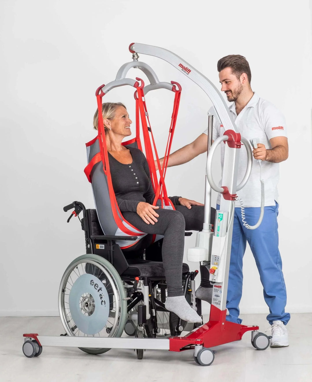 Molift - Mover 180 4-Point Sling Bar - lady being helped by nurse in portable lift