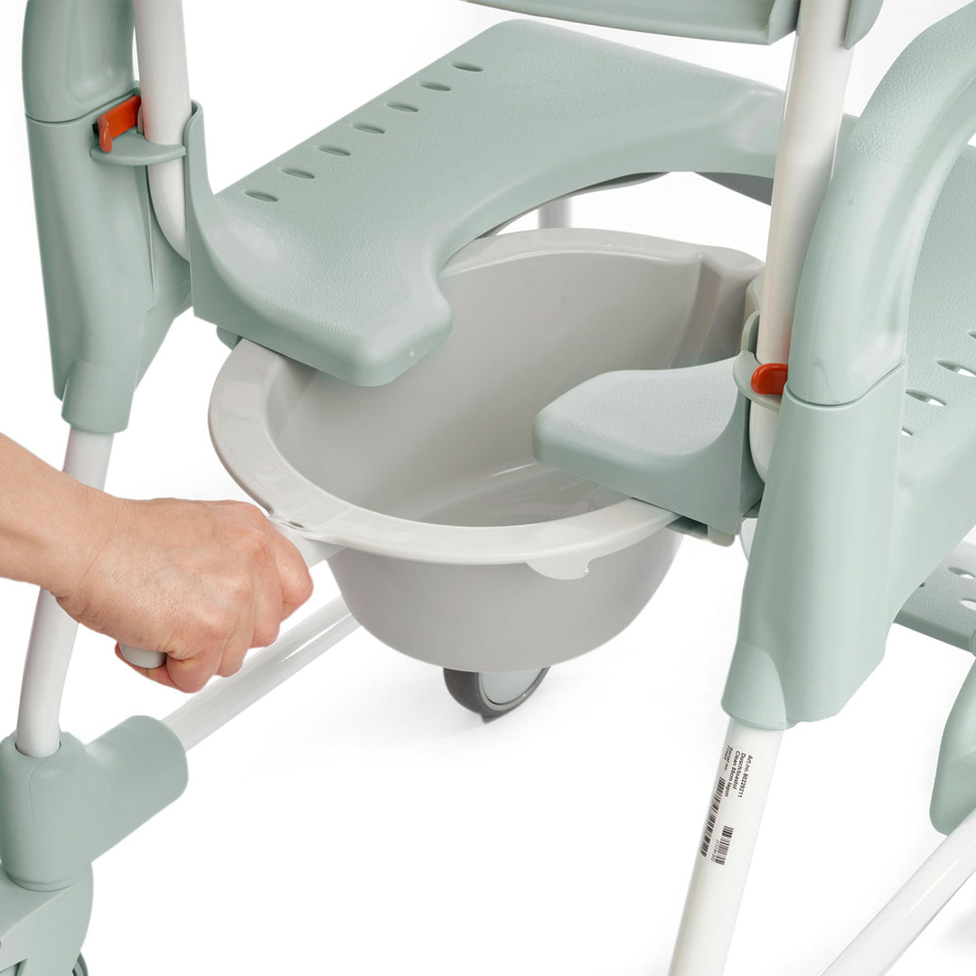 Hand holding a baby seat attachment on a high chair with a white background