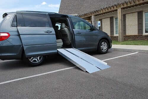 American Access - Sidekick Portable Aluminum Folding Wheelchair Van Ramp - ramp being used coming out of a minivan's side entrance