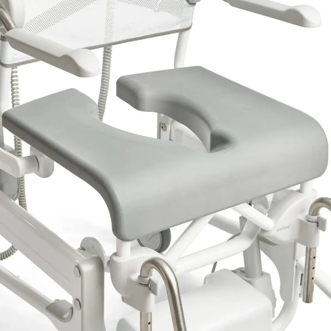 White medical examination table with adjustable armrests and footrests on a white background