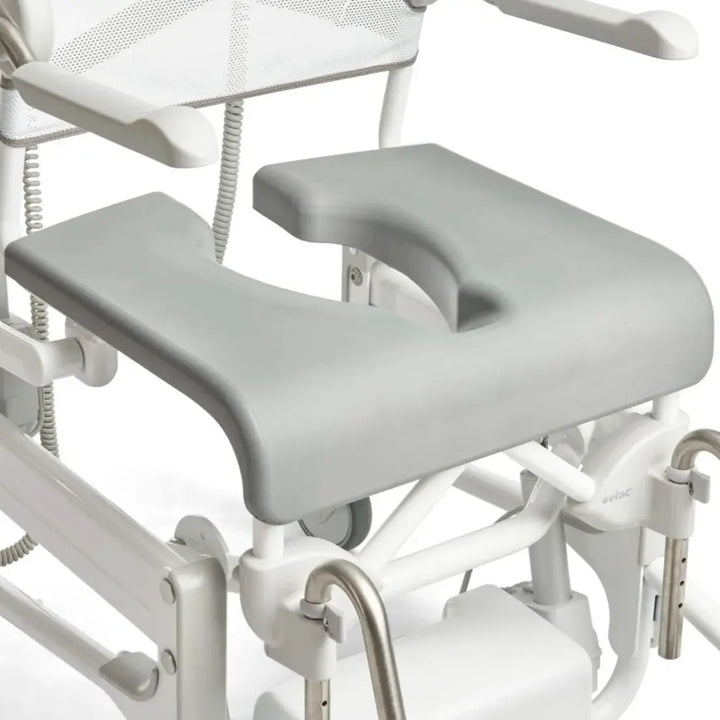 White medical examination table with adjustable armrests and footrests on a white background