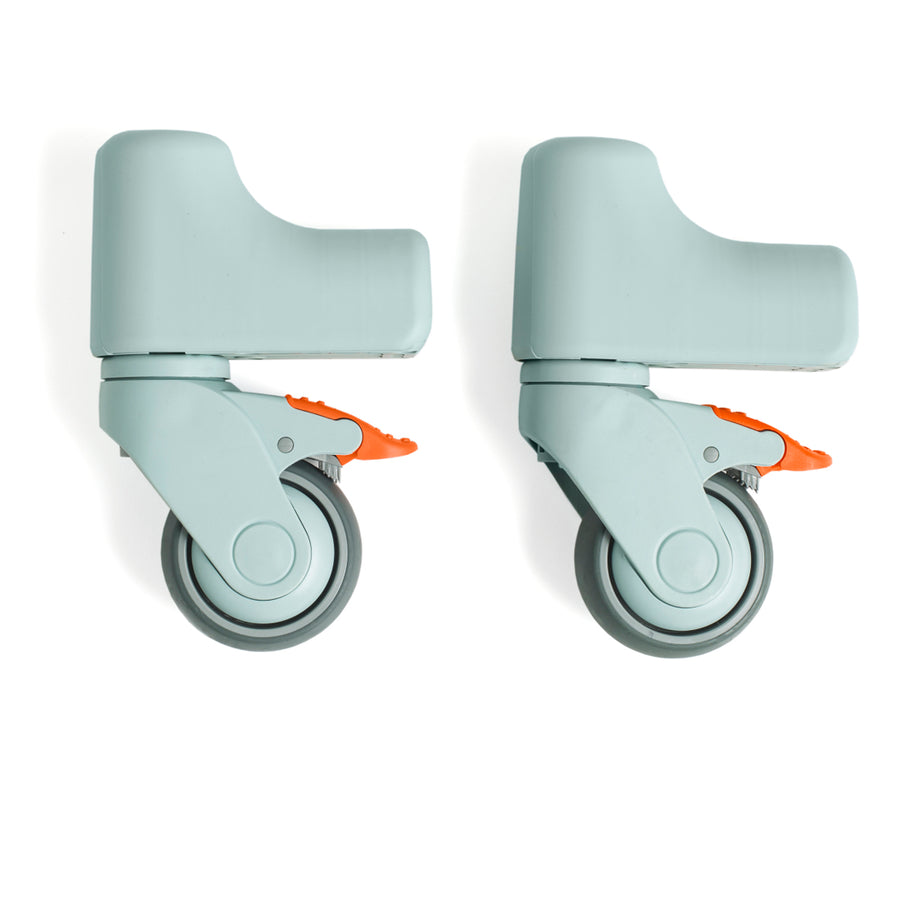 Two gray caster wheels with orange axles on a white background