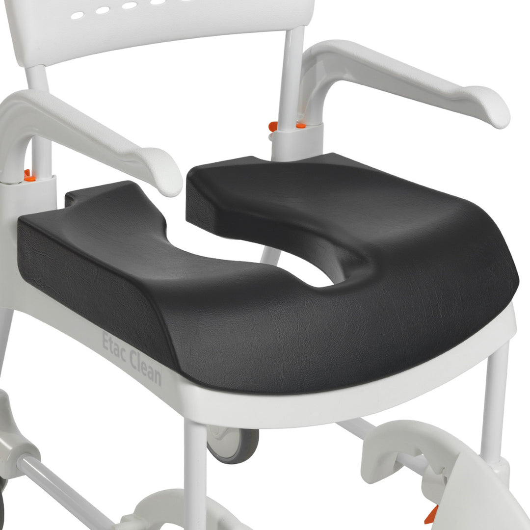 Black seat cushion on a white commode chair with 'ClevaMaid' branding.