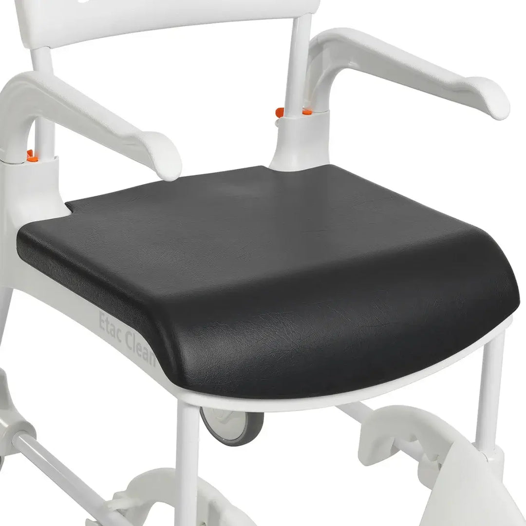 Black seat cushion on a white medical chair with visible branding.