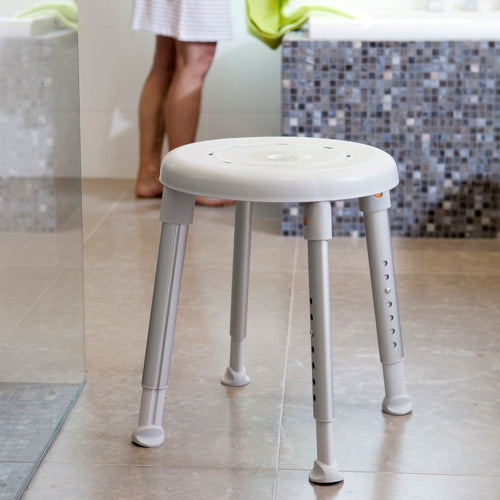 etac easy shower stool from reliable ramps outside the shower on tile floor