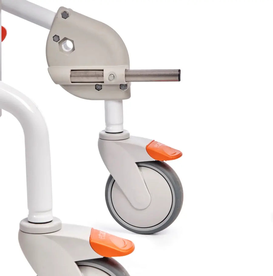 Close-up of a mobil commode with a focus on the wheel and suspension system on a white background