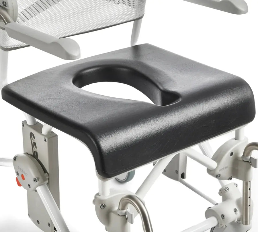 Black commode seat attached to a white wheelchair with a white background