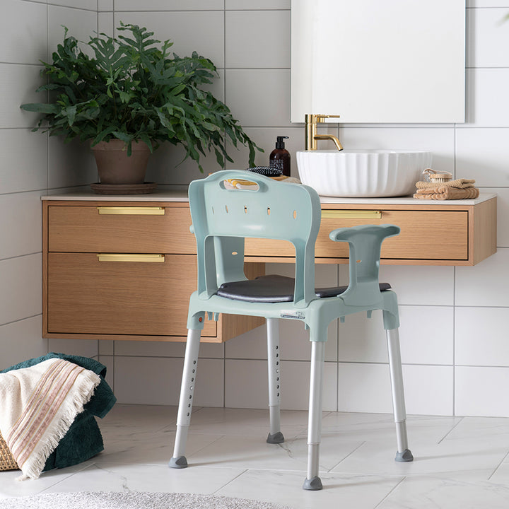 etac swift shower stool/chair from reliable ramps showing green variation with all parts includled
