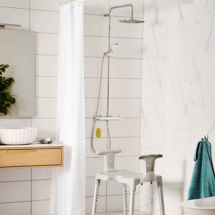 etac swift shower stool/chair from reliable ramps showing the arm handle variation in the shower