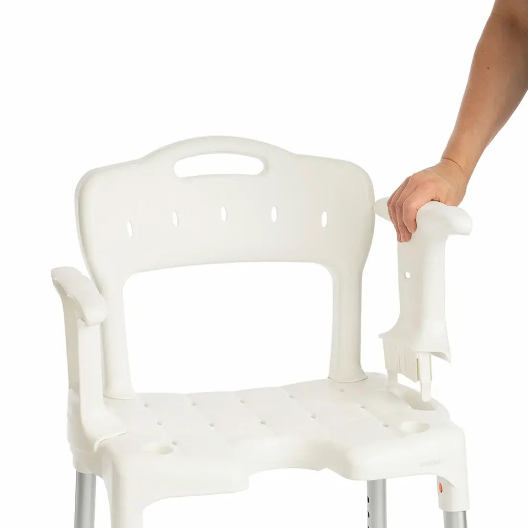 etac swift shower stool/chair from reliable ramps showing someone holding it with one hand