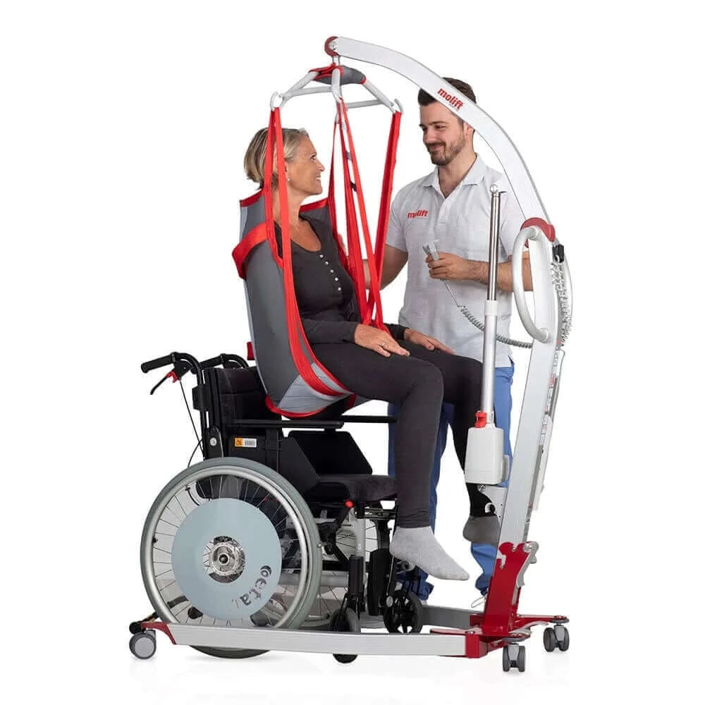 lady being helped out of her wheelchair by a nurse who