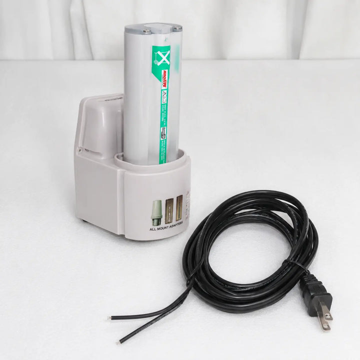 Electronic device with a cylindrical component and power cord on a white background
